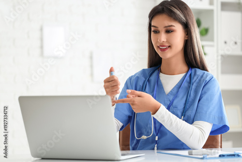 Female doctor with lancet p...