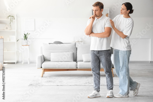 Young woman supporting sad man with suicidal thoughts at home