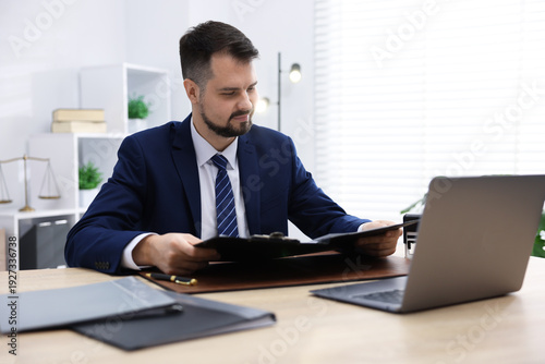 Notary working at wooden desk in office