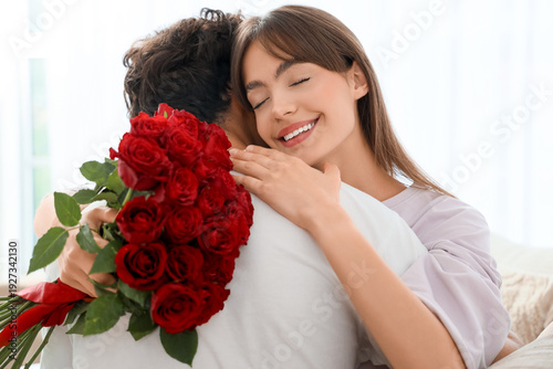 Young woman with red roses ...