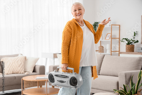 Senior woman with boombox a...