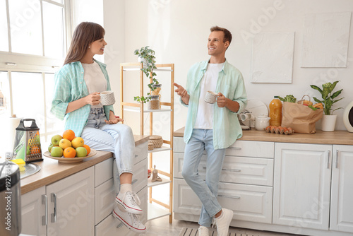 Young couple with cups of c...