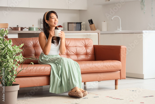 Young Asian woman with cup ...
