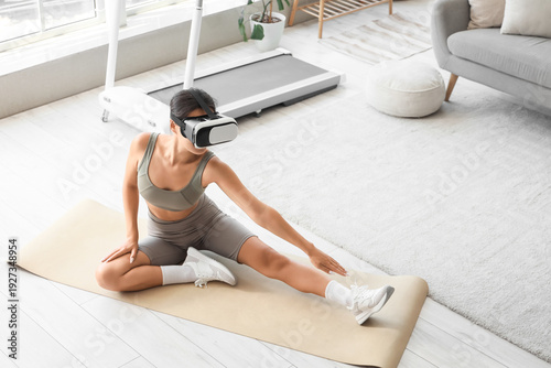 Sporty young woman in VR gl...
