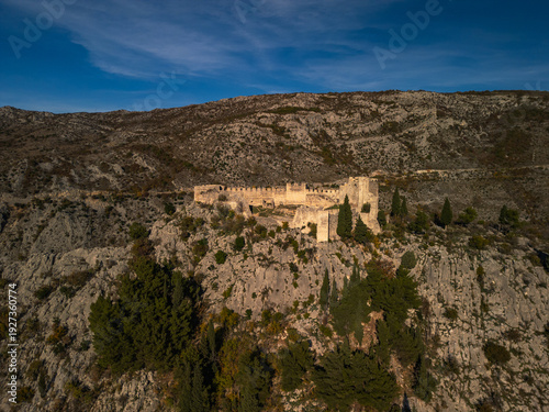 Canvastavla Blagaj Teke dervish monastery and medieval stone fortress castle aerial drone panorama view in Bosnia