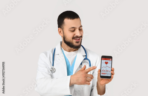 Young happy male doctor wit...