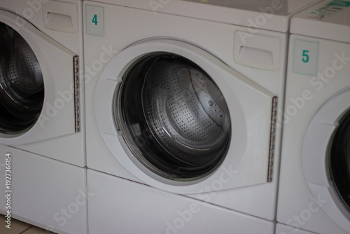 Wallpaper Mural Row of white self service washing machines with visible numbering close up Torontodigital.ca