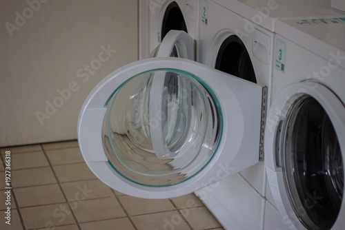 Wallpaper Mural Open washing machine door in self service laundromat close up Torontodigital.ca