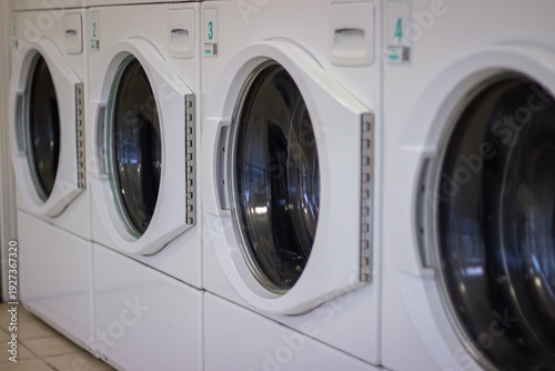 Wallpaper Mural Row of self service washing machines in modern laundromat close up Torontodigital.ca