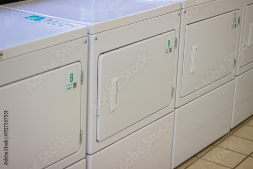 Wallpaper Mural Row of self service dryers with visible numbering in laundromat Torontodigital.ca