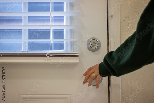 Wallpaper Mural Woman hand opening front door with metal doorknob Torontodigital.ca