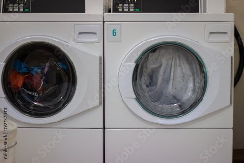 Wallpaper Mural Two tumble dryers running with laundry spinning in self service laundromat Torontodigital.ca