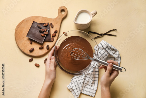 Female hands whisking melte...