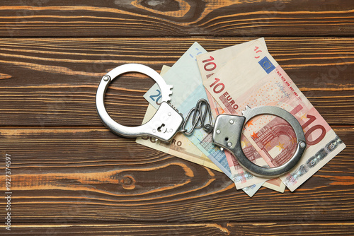 Handcuffs with euro banknot...