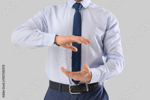 Businessman holding somethi...