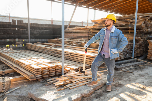 Male carpenter in hardhat w...