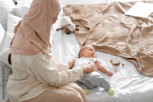 Muslim mother in hijab with...