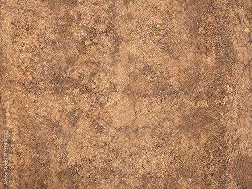 Organic brown dirtied earth ground texture background of dry land surface with natural cracks. Soil Texture