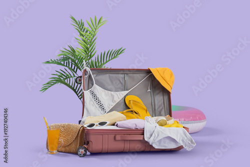 Open suitcase with beach ac...