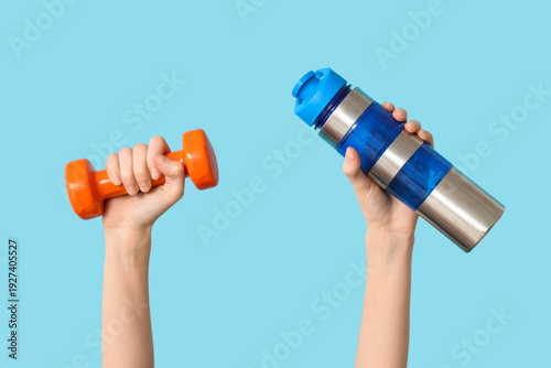 Female hands with dumbbell ...