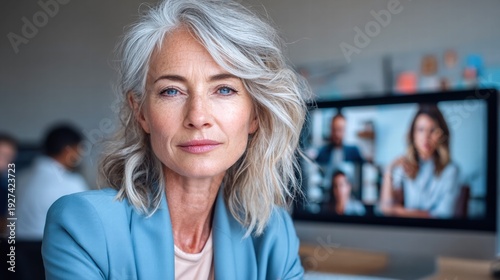 A confident businesswoman participates in a video conference call in her office. Free Download A confident businesswoman participates in a video conference call in her office. - GFXLoad