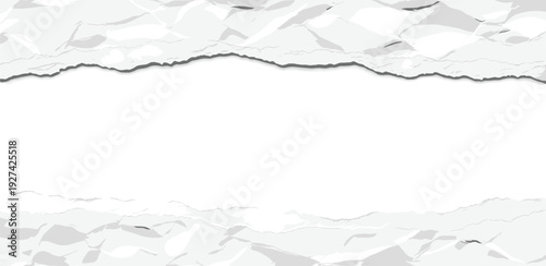 A high-angle view of a torn paper edge on a white textured background with crumpled fragments