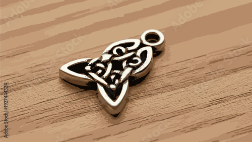 Close-up of a gold-colored star-shaped pendant with intricate design on a wooden surface with a warm, earthy tone.