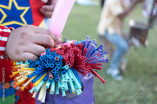 Wallpaper Mural Close up of a freelance clown creating balloon animals and different shapes at an outdoor event. The concept of entertainment, birthdays Torontodigital.ca