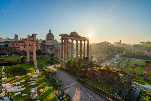 Roman forum ruins at sunrise in Rome with Inscription "Senatus Populusque Romanus incendio consumptum restituit" - The Senate and People of Rome restored what had been consumed by fire