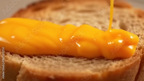 Golden stream of rich, delicious melting cheese cascading onto crispy toast