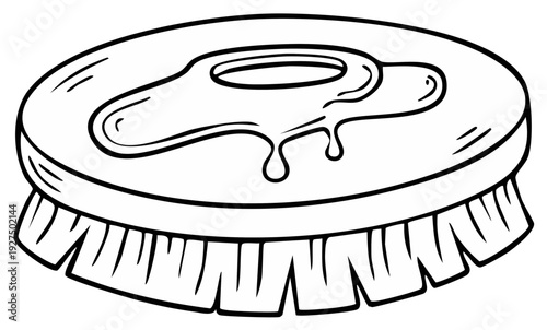 Cartoon drawing of a round cleaning brush with bristles and drip