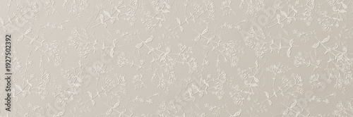 Fotografie A subtle white embossed floral pattern with delicate leaves and blossoms creating an elegant textured wallpaper background