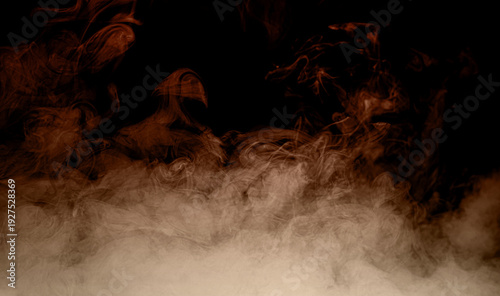 Fotografie Dark smoke swirling over black background with dramatic mist and fog texture
