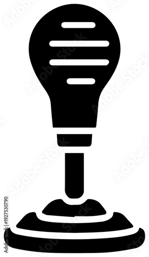 Stylized black filled icon representing a manual gear shifter knob with horizontal lines on top situated on a textured base symbolizing automotive transmission and driving control