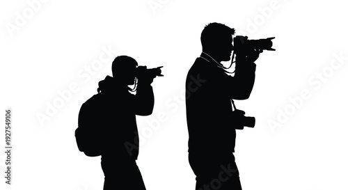 Two photographers with cameras captured in a striking black silhouette