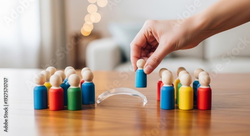 Hand placing a wooden figure across a clear barrier