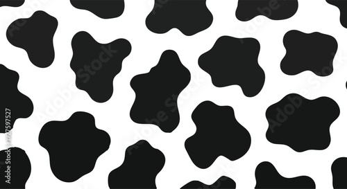 Seamless black and white cowhide animal print pattern with irregular organic spots