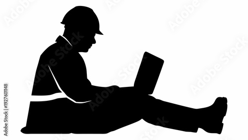 Engineer working on laptop while sitting on floor