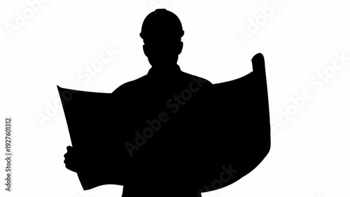 Man in silhouette reading large document or blueprint closely