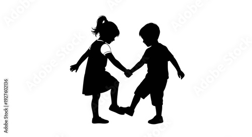 Two children holding hands walking together outdoors in silhouette