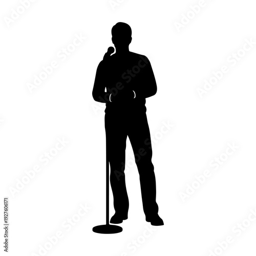 Silhouette of a man speaking into a microphone on a stand.