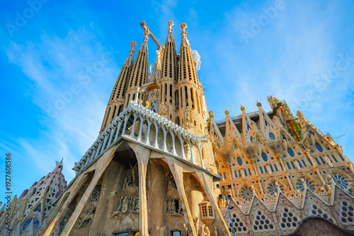 View of the unfinished Sagrada Familia on a sunny day in Barcelona, Spain. Sagrada Familia is a famous landmark symbolizing Barcelona’s cultural, religious, and architectural heritage.