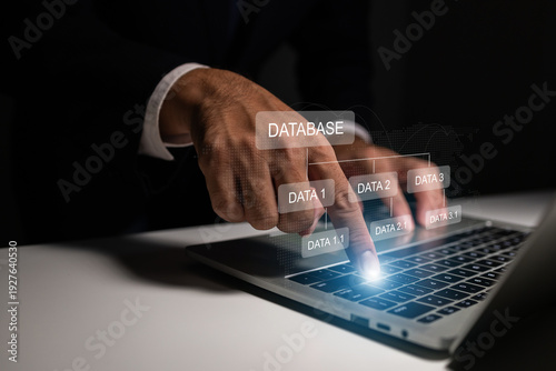 Businessman managing database system on laptop, organizing digital information and ensuring secure data processing for efficient enterprise operations.