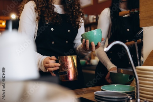 Barista preparing coffee with steamed milk