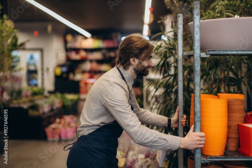 Florist moving shelf with pots in garden center