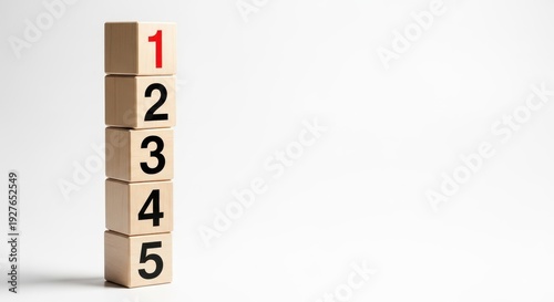 Stack of five wooden blocks with numbers 1 to 5, red number one on top, isolated on white background