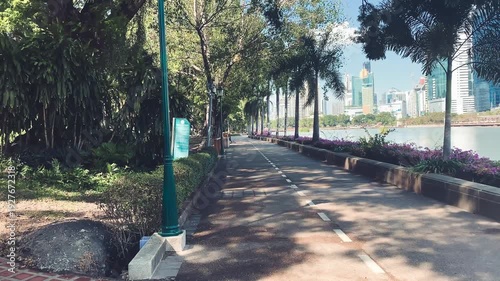 Wallpaper Mural BANGKOK, THAILAND - DECEMBER 16, 2019: Benjakitti Park with city buildings on a sunny day, slow motion Torontodigital.ca