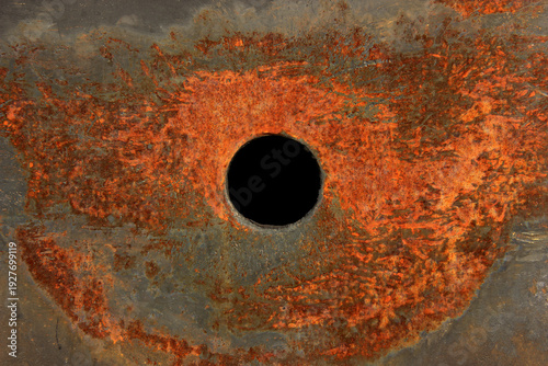 Old rusty train metal exterior with a circle black hole in the middle