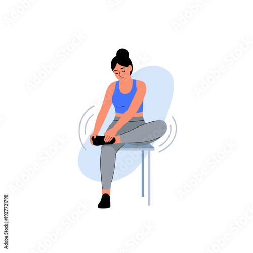 Young asian female massaging foot while seated on a chair, wearing activewear