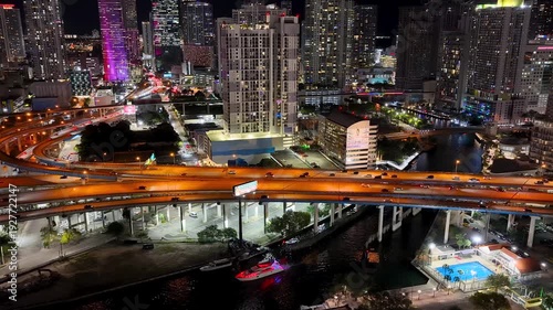 Aerial view of colorful buildings and traffic on highway in Miami downtown at night